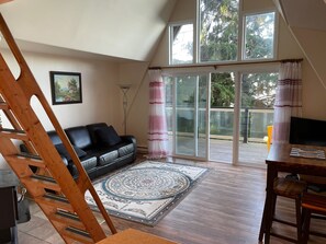 Huge windows and glass doors fill the living/dining area with natural light.