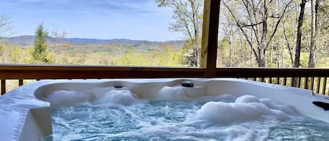 Relax & unwind in the bubbly hot tub while enjoying spacious mountain views 