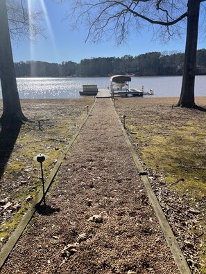 View of the dock and water from backyard, park-like setting!