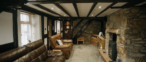 Living room space, with fire place, smart TV and two sofas