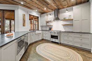 Prepare gourmet meals in the spacious chef's kitchen complete with a gas range stove, a spacious farmhouse sink & a dishwasher.