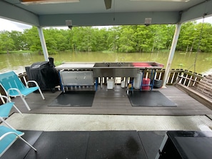 Back deck with fish cleaning station, grill and porch swing