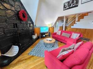 Main Floor Living Room with Roku TV and Wood Burning Fireplace