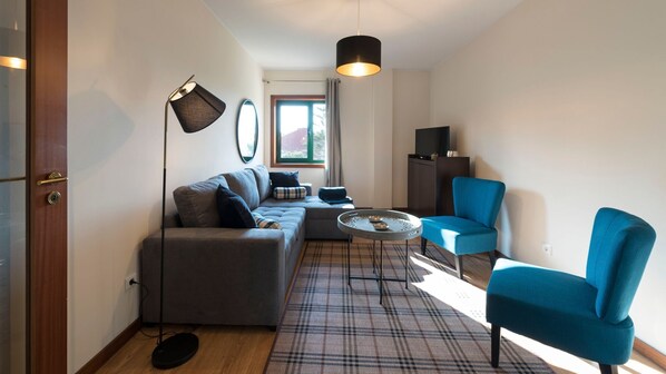 A living room with a cozy sofa for 2 and a TV, so that you can relax and enjoy your favorite programs #airbnb #airbnbporto #portugal #pt #porto