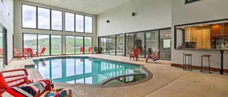 Full view of indoor pool with full window / door access to the side yard and lake