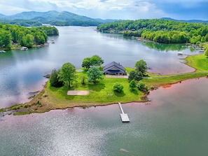 Arial view of home on its own peninsula of the lake.