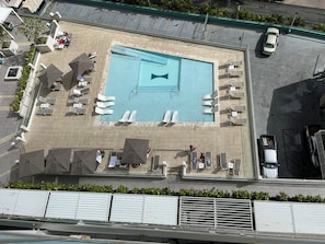 View looking down from the lanai (balcony) of the unit to the lounging pool.