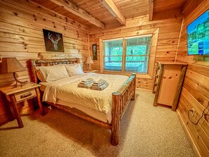 Main level bedroom with queen size bed and 32" Roku TV