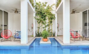 Shared pool area with grill in small boutique property.