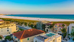 Yes, you are that close to the beach!  The aerial view of rooftop patio with Siesta Key Beach and the Gulf right there.  Beach access 11 is just across the street in the clearing.