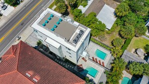 An aerial view with the rooftop patio and both pools and patios.