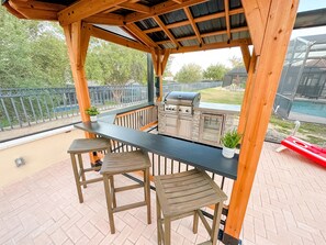 Our new covered outdoor kitchen includes a propane BBQ and mini-fridge.