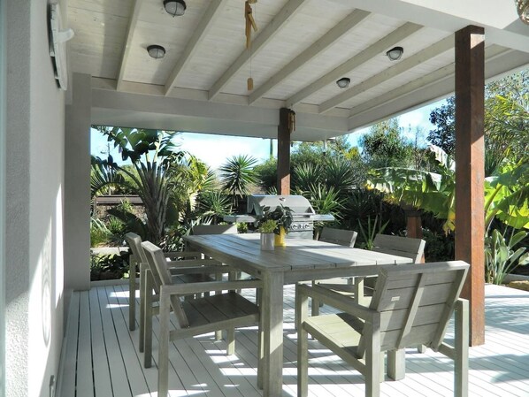 Deck, BBQ, outdoor furniture, gardens.