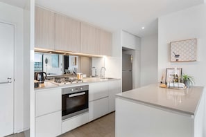 A Long and spacious kitchen. The laundry is at the back on the right, pantry and fridge/freezer is opposite on the left. Has every thing you need to cook a meal - Microwave - Dishwasher