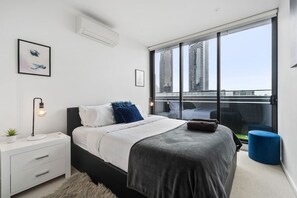 Main bedroom with a Queen size bed with soft plush mattress - Access to balcony through glass sliding doors.- Walk in mirrored wardrobe area,- Ensuite- Split system heating & Cooling.