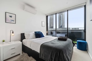 Main bedroom with a king size bed, walk in robe area, en-suite and access to balcony through glass sliding doors - Split system heating and cooling.