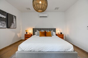 Luxurious bedroom of the villa in Noord, Aruba - Comfy king size bed - Elegantly designed room beautifully decored with large aesthetic wall paintings - Majestic table lamps and elite chandelier - Neat and clean linen with soft pillows