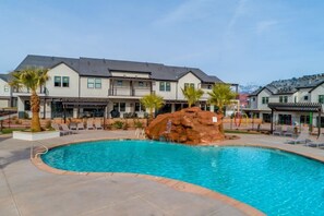 Resort pool with waterslide and shallow end beach entry