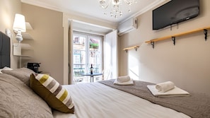 A spacious bedroom with a double size bed and its cozy linen, an A/C and a TV #airbnb #airbnblisbon #portugal #pt #lisbon