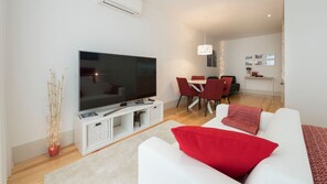 Bright and modern living room with a comfy sofa and a big screen TV #airbnb #airbnbporto #portugal #pt #porto