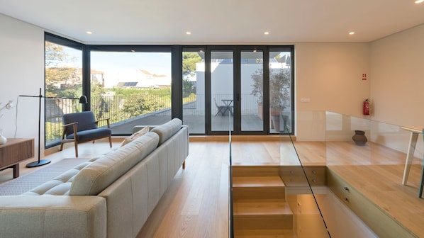 Spacious and bright living room with a connection to the property's balcony #airbnbporto #portugal #porto #spacious #bright