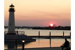 Beautiful sunset view over the light house at the Harbor