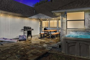 Relax in the spa in the private backyard. 