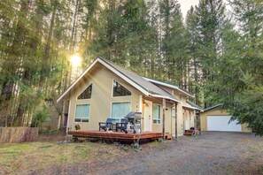 The cabin is nestled in a picturesque neighborhood surrounded by lush trees.