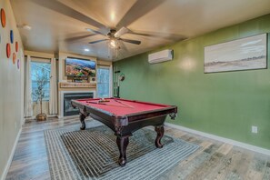 Entertainment Hub – A game room featuring a pool table and vibrant decor