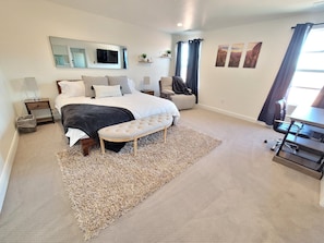 Large master bedroom with comfortable king size bed.