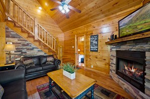 Spacious living room with sofa, loveseat, fireplace, and TV