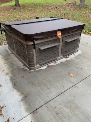 Hot tub located on back patio. 