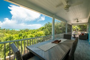 Large screened-in balcony overlooking Elizabeth Harbor (table and couch).
