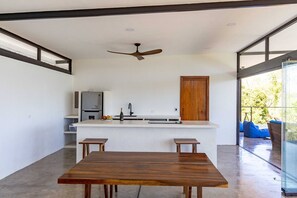 Living and kitchen with open glass front