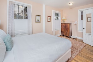 Bedroom 1 with queen bed and half bath.