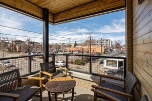 Balcony with outdoor seating accessed via the living room.