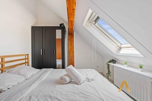 Peaceful Bedroom Retreat – Unwind in the cozy bedroom with a comfortable double bed, soft linens, and a skylight for a bright, airy feel.