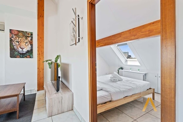 Bright & Cozy Living Space – Relax in a stylish open-plan living area with a comfortable sofa, Smart TV, and plenty of natural light.