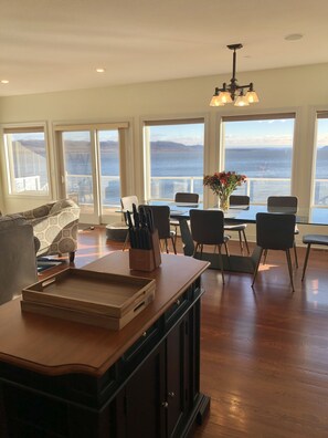 Large glass dining room table with lake view. Seats 8 to 10.