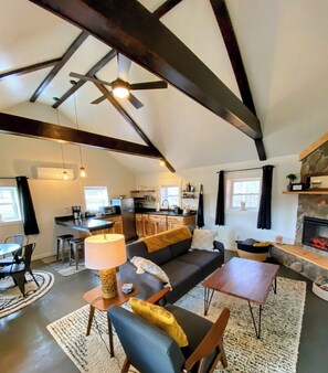 The Tiger Lily features a vaulted ceiling, abundant natural light, & fireplace.