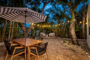 Enjoy exotic cocktails on the Chicago Brick/string-lit romantic backyard