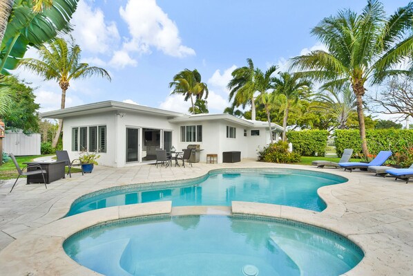 Quality family home, enticing yard with pool, spa tub, outdoor dining and tropical planting.
