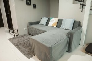 Large sofa featuring a chaise & a full-size pullout bed for extra sleeping space