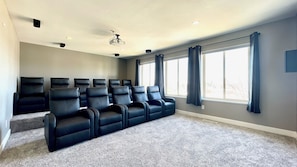 The theater room! Includes 11 reclining theater seats and 120" screen