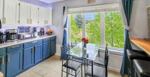 Dine with greenery views—coffee bar on left, breakfast bar on right.