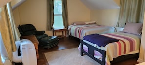 Bedroom- Queen bed & Twin bed. sitting chair, t.v. portable AC unit