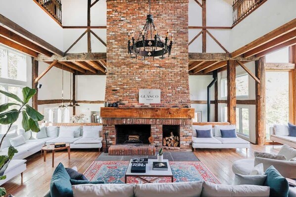 The Grand Fireplace is the centerpiece of the home. Many gasp upon entering the main room. Between the Fireplace and the full windows with stunning views, it's hard not to!