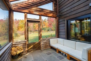 The Screened back porch is the perfect place for an outdoor dinner, or just to hang out in the summer time. The sunlight streaming through the clear ceiling all day makes it a magical experience.