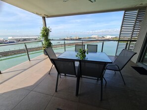 Balcony view towards the harbour and cruise ship terminal.  Wharf eatery on LHS.