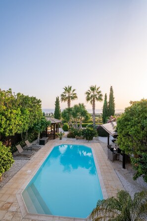 Enjoy a refreshing dip in the large swimming pool, newly refinished with easy-access staircase and extra-high skimmers. Solar-heated shower for rinsing off. Pool heating is available during the cooler months for an added fee, ensuring year-round comfort.
